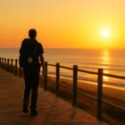 caminho budget tips - Pilgrim with backpack and scallop shell walking a wooden boardwalk at sunrise on the Portuguese Coastal Camino, evoking affordable travel and minimalist budgeting.